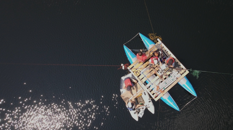 Researchers led by Professor of Earth Sciences Meredith Kelly dig for sediments in New Hampshire's Sky Pond (Photo by Northwest Sound Mixer)